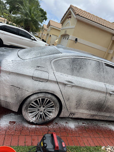 Frosty white car covered in snow or foam after car wash