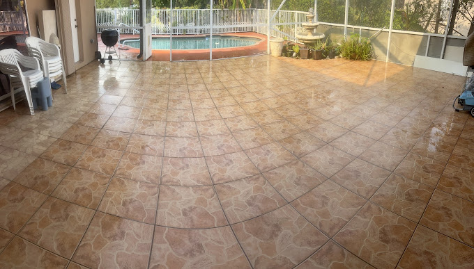 Indoor covered patio with tiled floor, swimming pool, and outdoor view