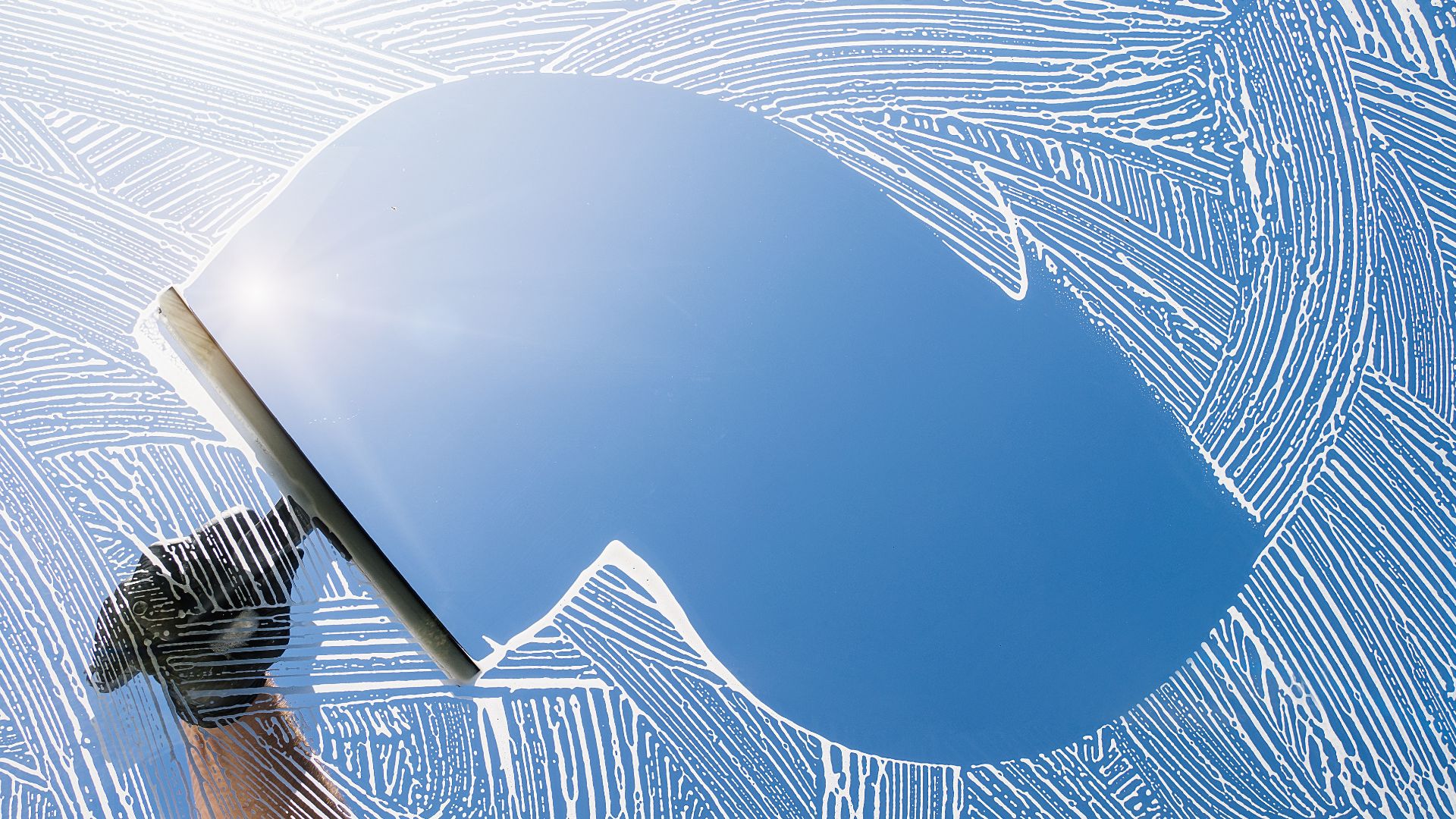 Blue curved surface with fingerprint-like patterns and metallic rod